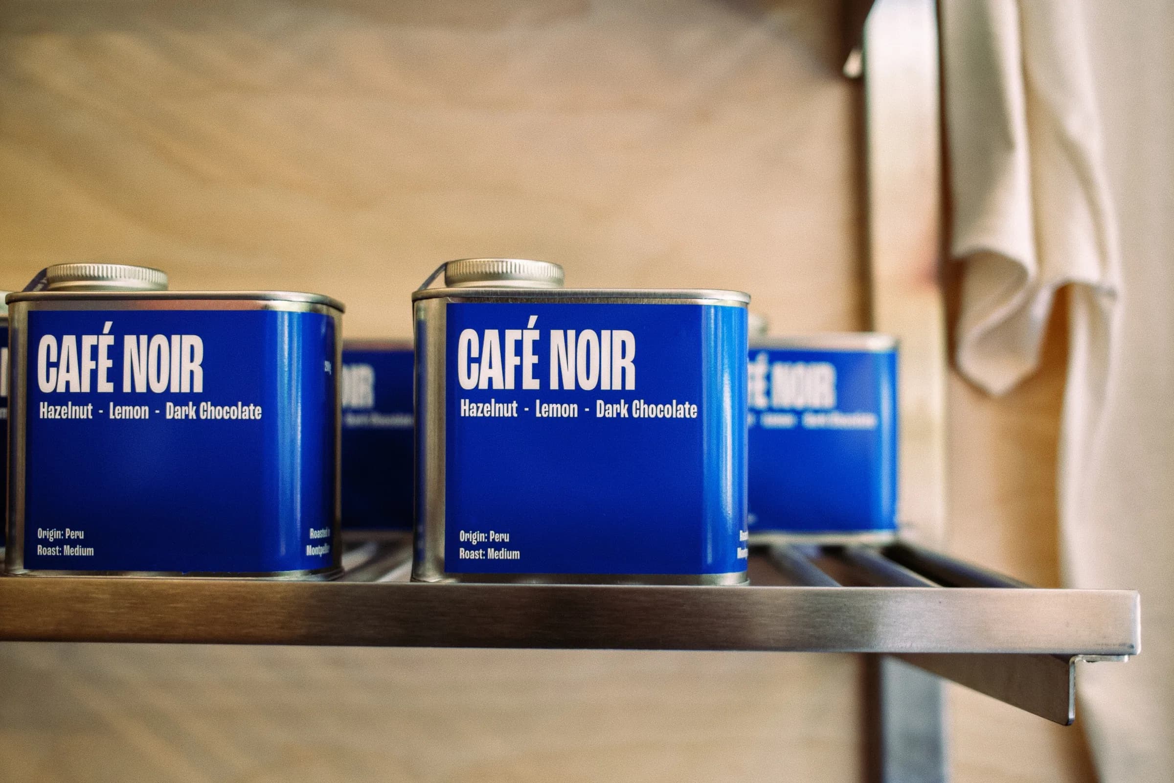 Blue Café Noir coffee tins on a shelf
