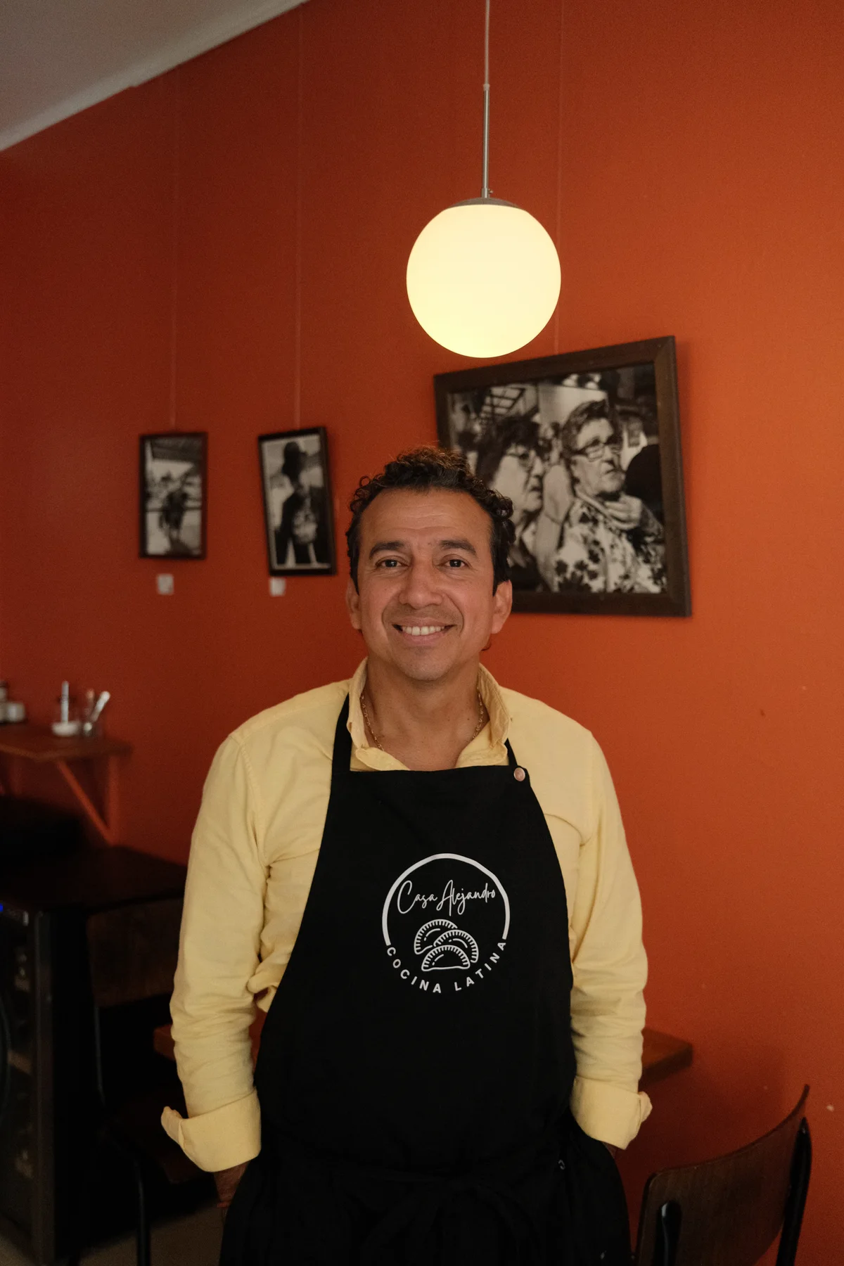 Alejandro in an apron in Casa Alejandro's dining room