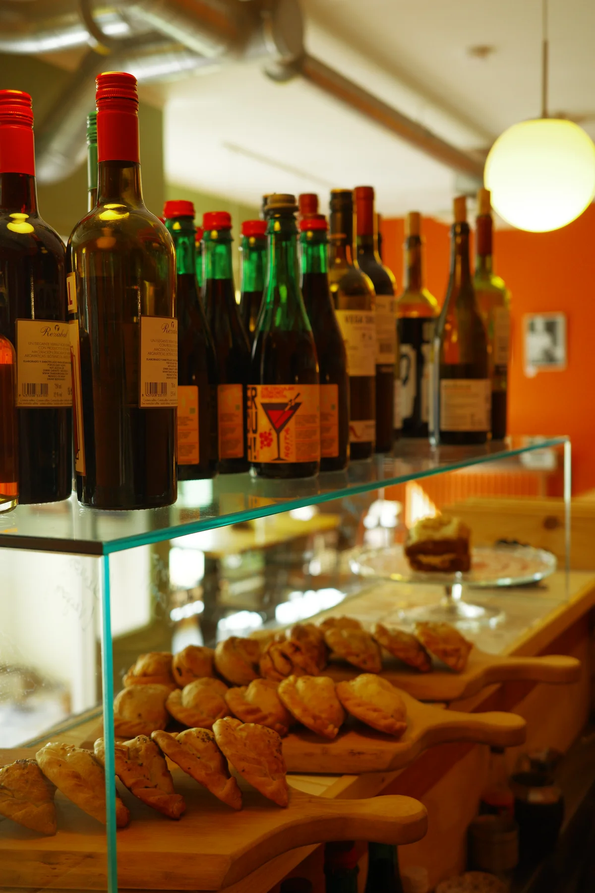 Wine bottles above a display of empanadas at Casa Alejandro