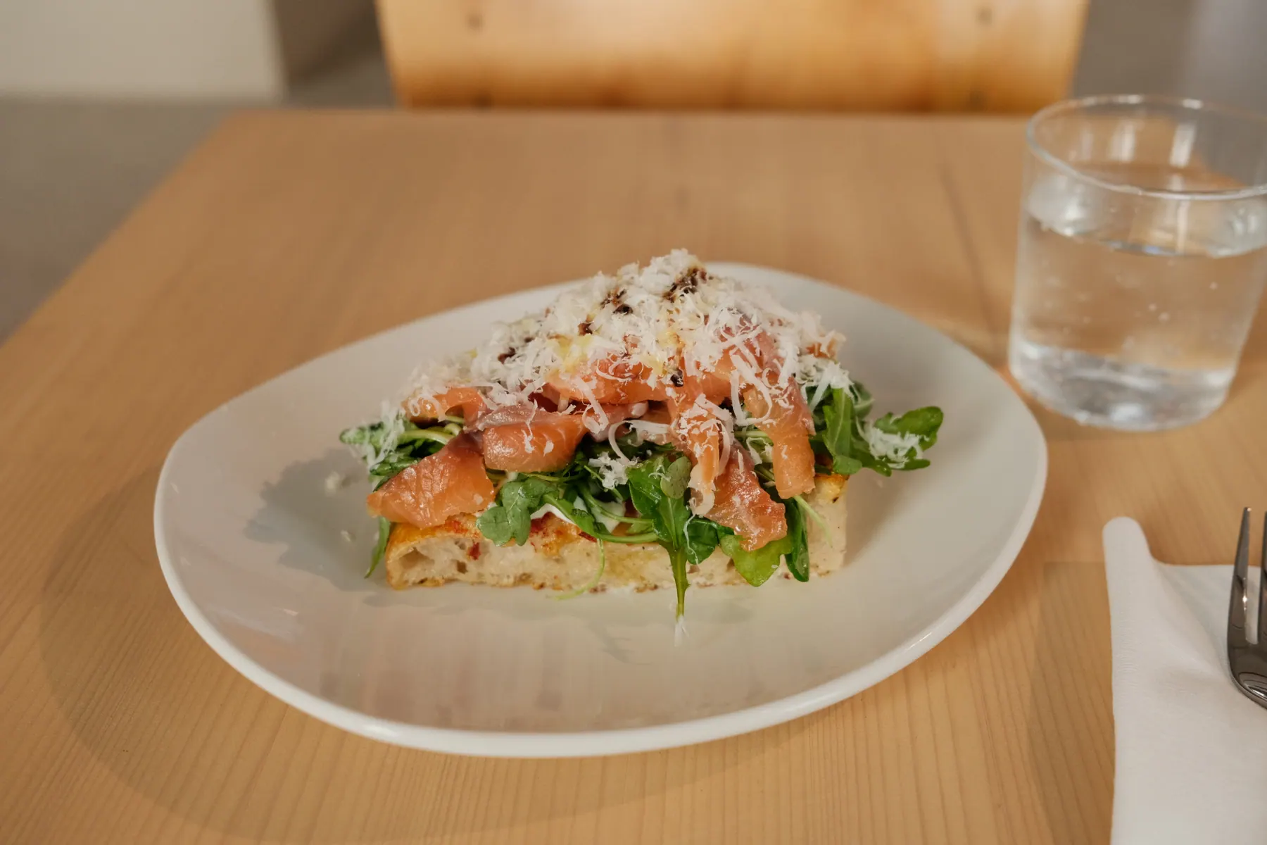 A freshly topped focaccia served on a plate at Focaccina