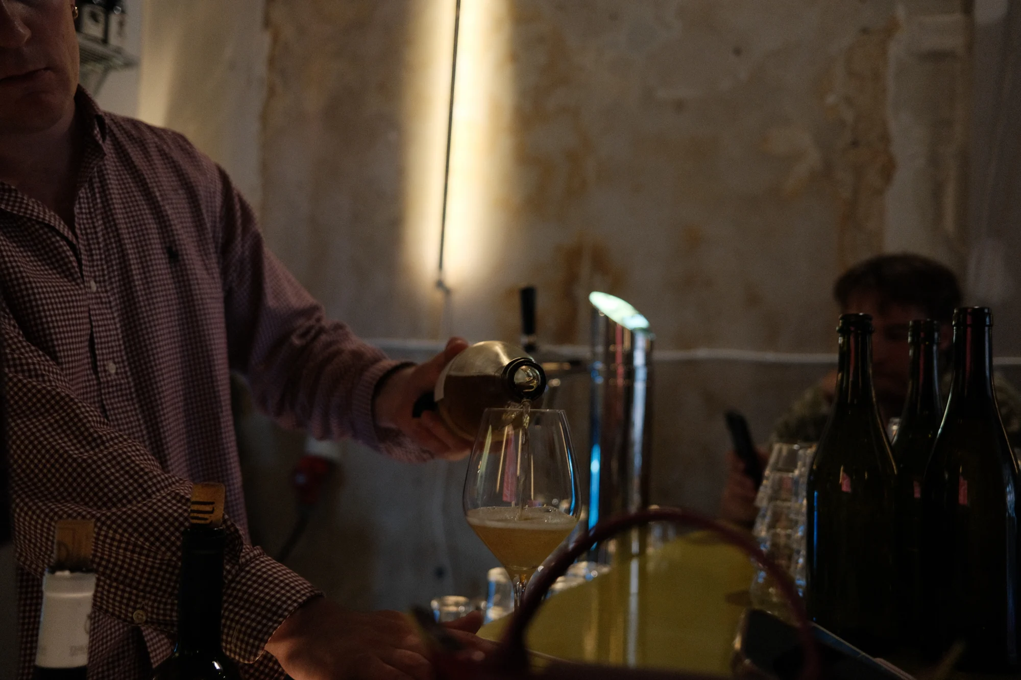 Gadeplan staff pouring wine behind the counter