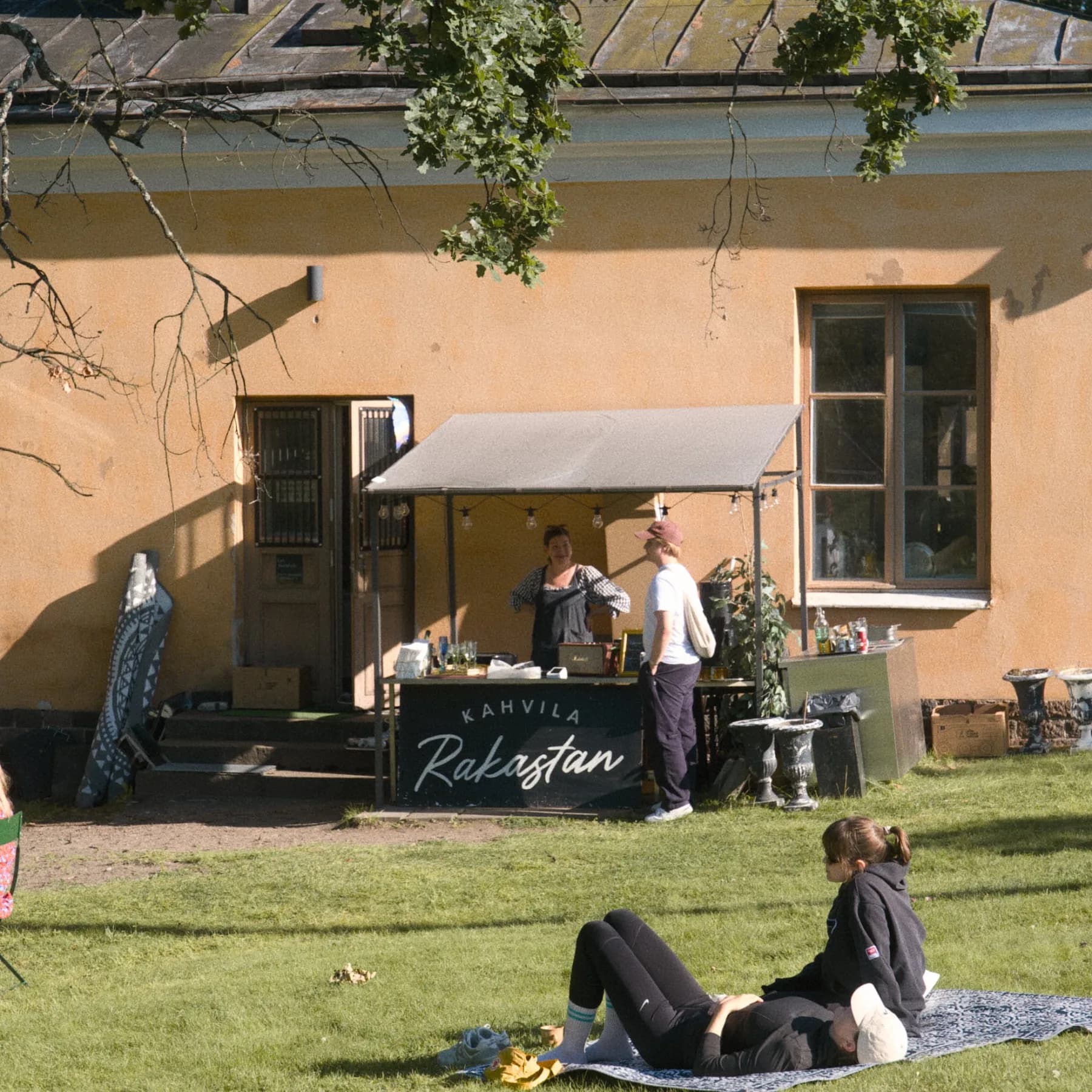 Kahvila Rakastan back terrace counter with the café sign visible