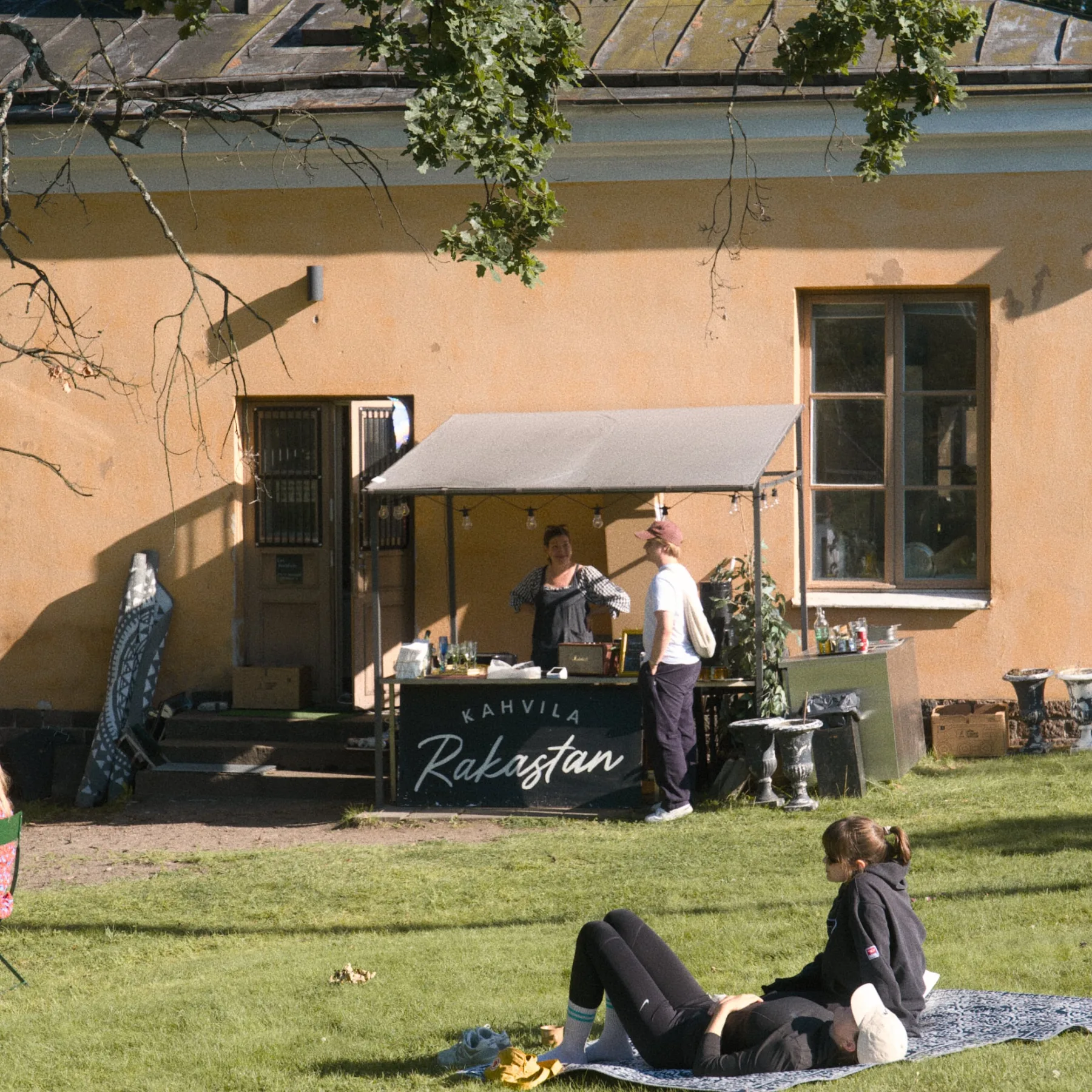 Kahvila Rakastan back terrace counter with the café sign visible
