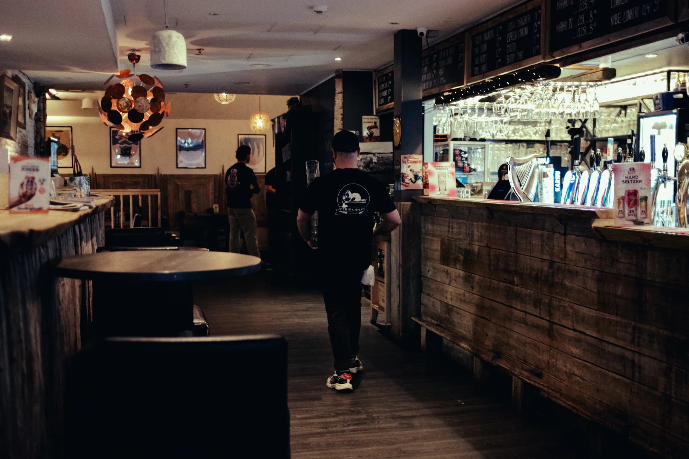 Pub Peräkammari bar interior with the counter, taps, and warm lights