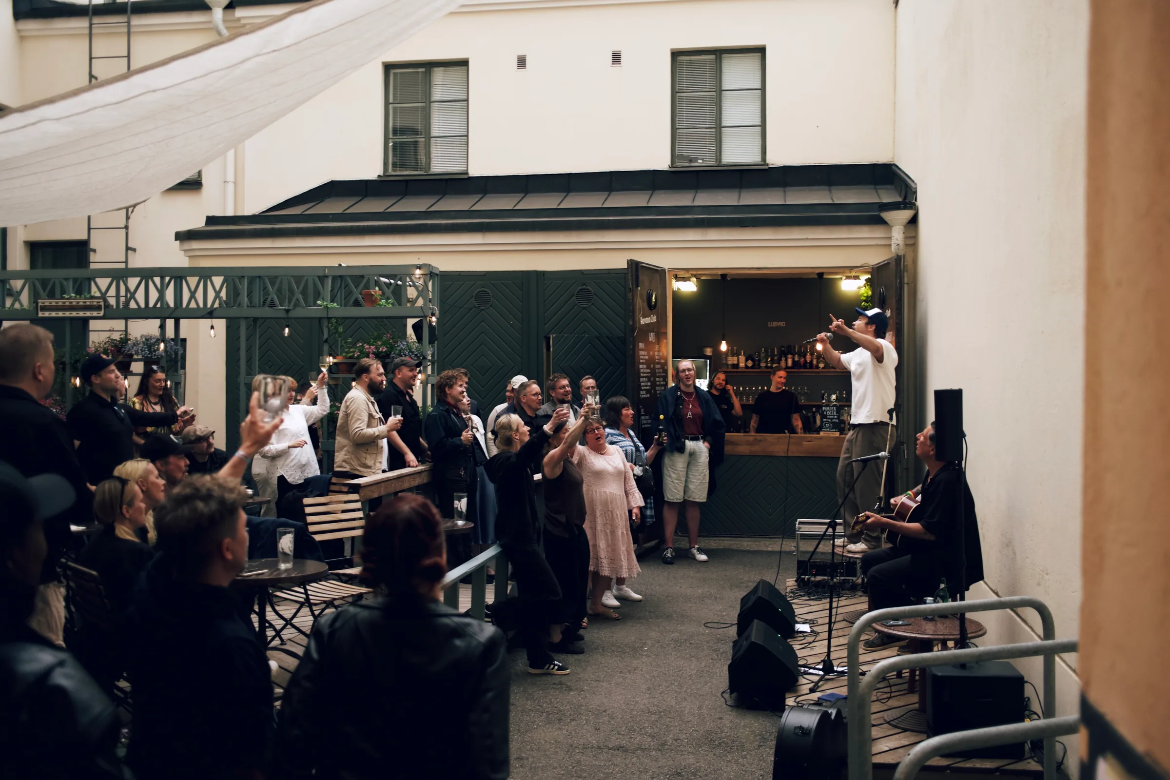 Pub Ludvig courtyard with guests gathered for a summer event in Helsinki