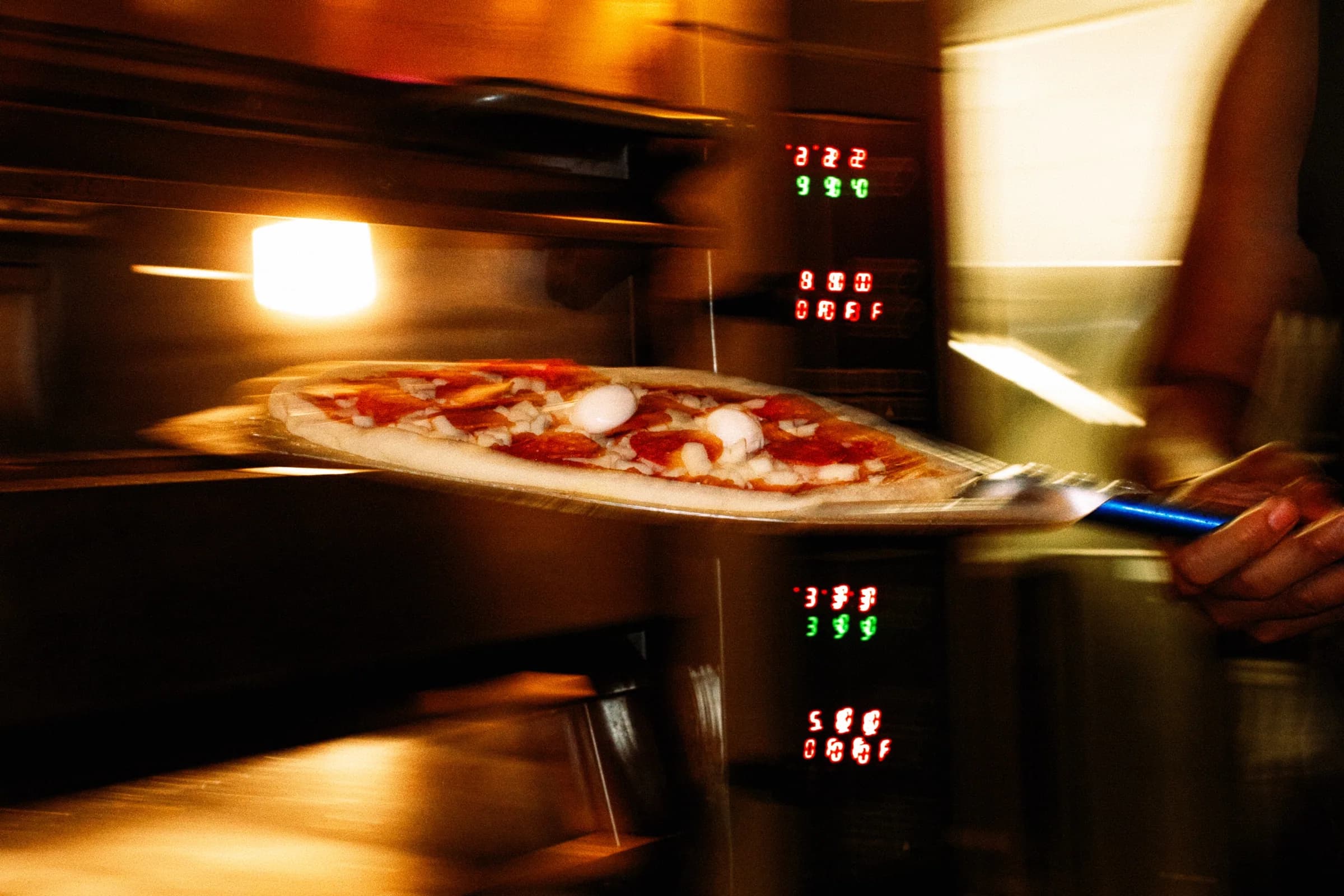 A pizza sliding into the oven at Putte's Bar and Pizza