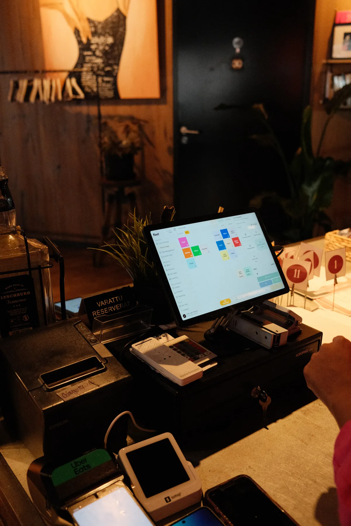 The Fiest point of sale open on a tablet among Tinku's payment devices and order numbers